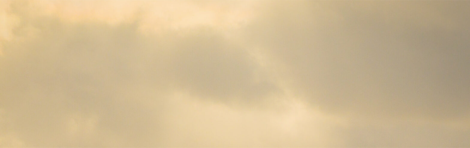 A soft, muted sky with gentle clouds at sunset.