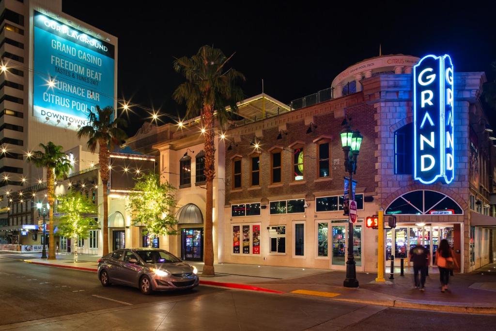 City street with illuminated casino at night.