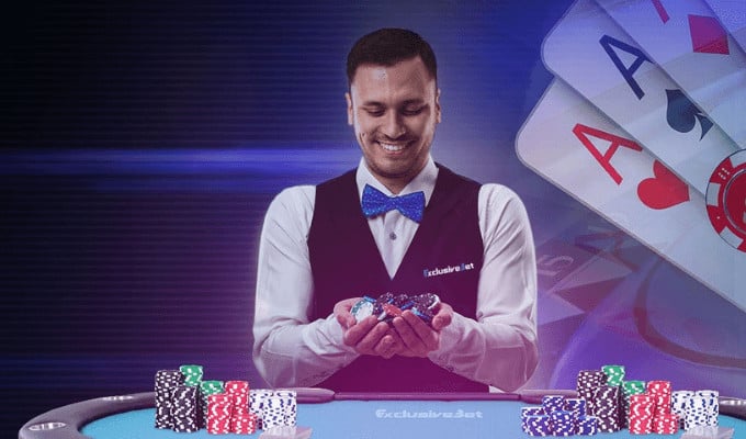 Smiling dealer holding poker chips, playing cards.