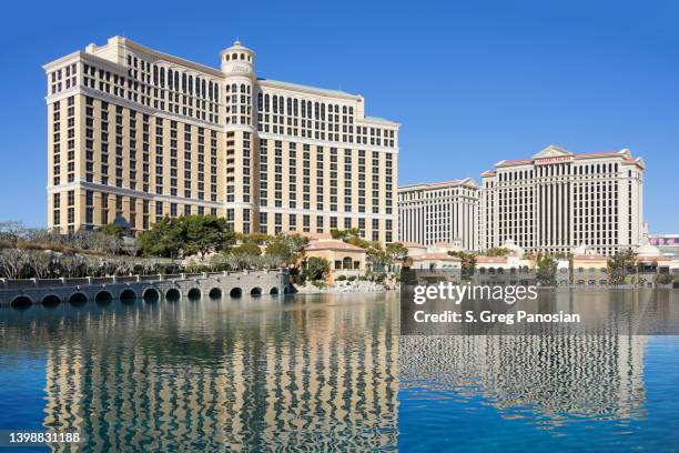 Large hotel with reflection in water.