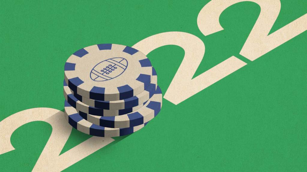 Poker chips on green 2022 background.