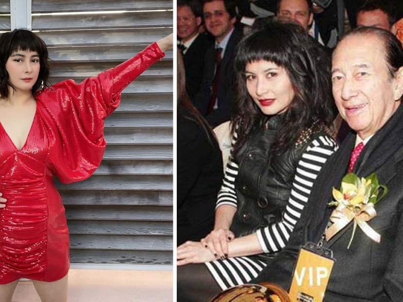 Woman in red dress; event attendees smiling.