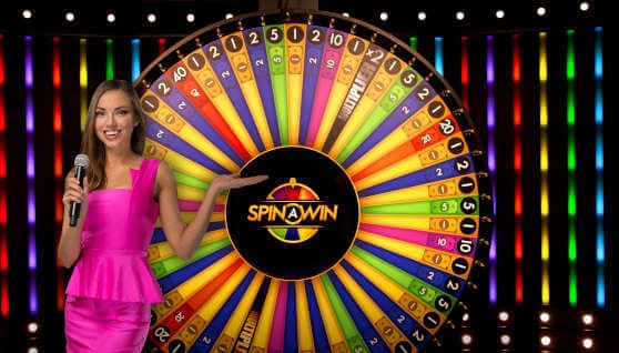 Game show host with colorful spinning wheel.
